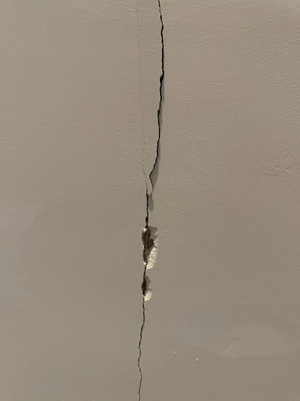 Before photo of cracked damaged drywall needing repair