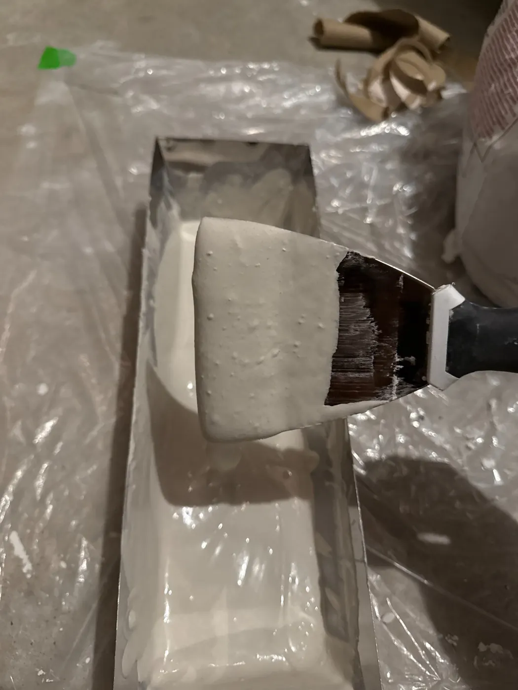Drywall knife with texture material during repair process